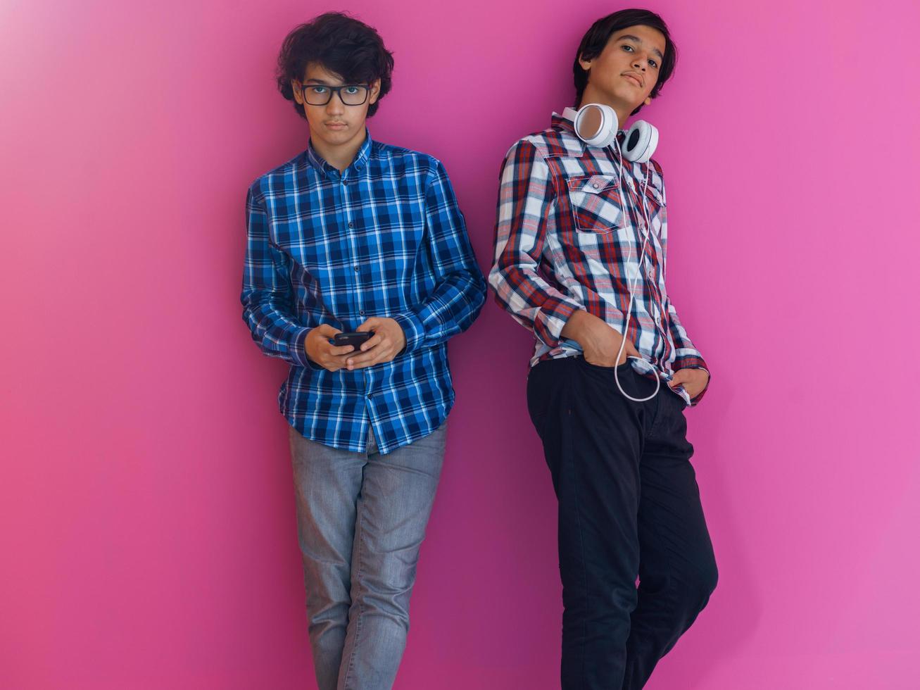 Arabic teenagers group portrait against pink wall photo