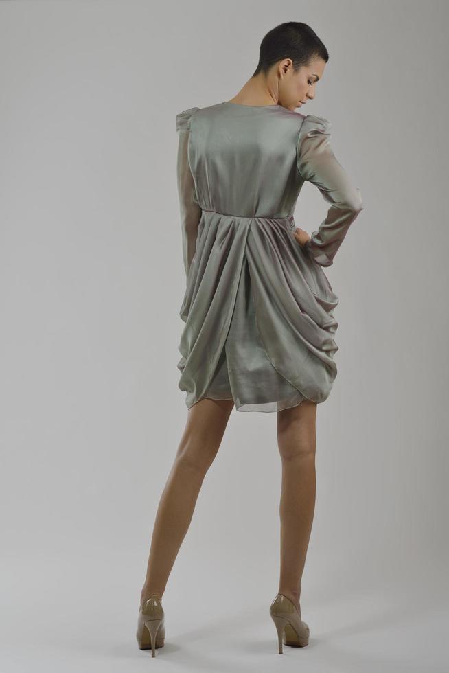 elegant woman in fashionable dress posing in the studio photo