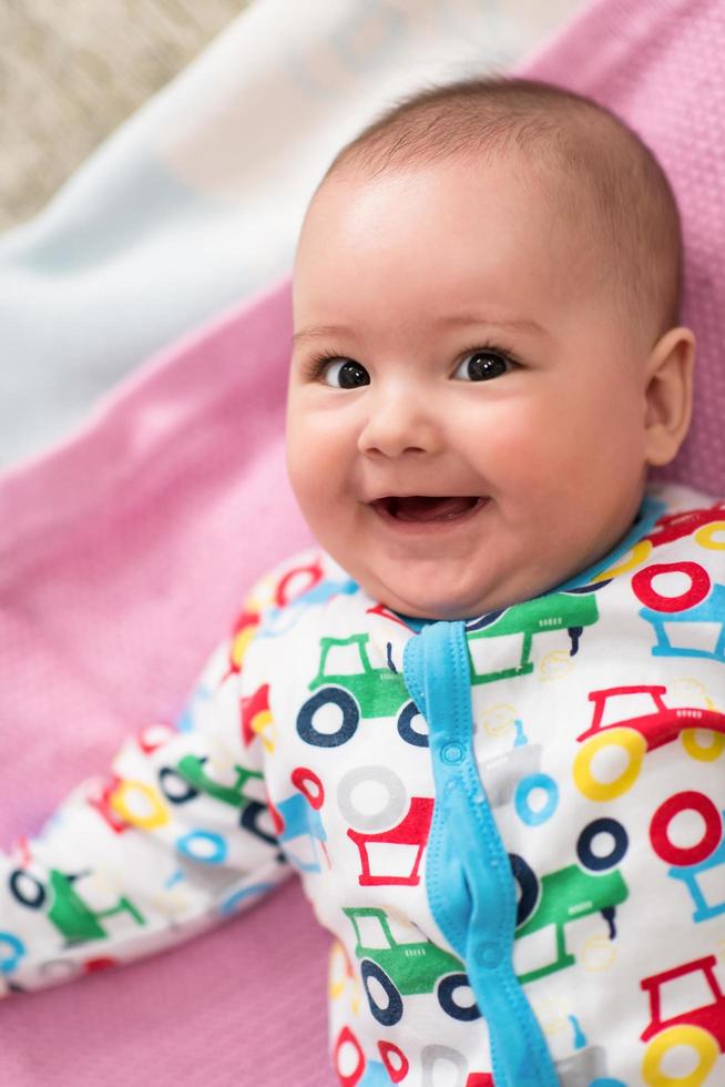 top view of newborn baby boy lying on colorful blankets photo