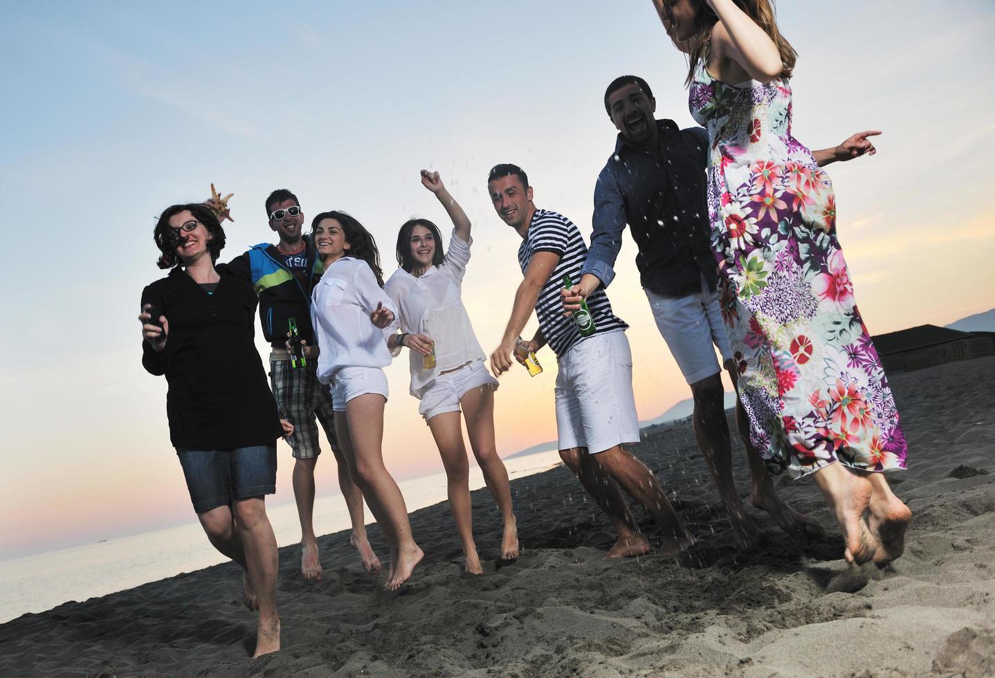 Group of young people enjoy summer  party at the beach photo