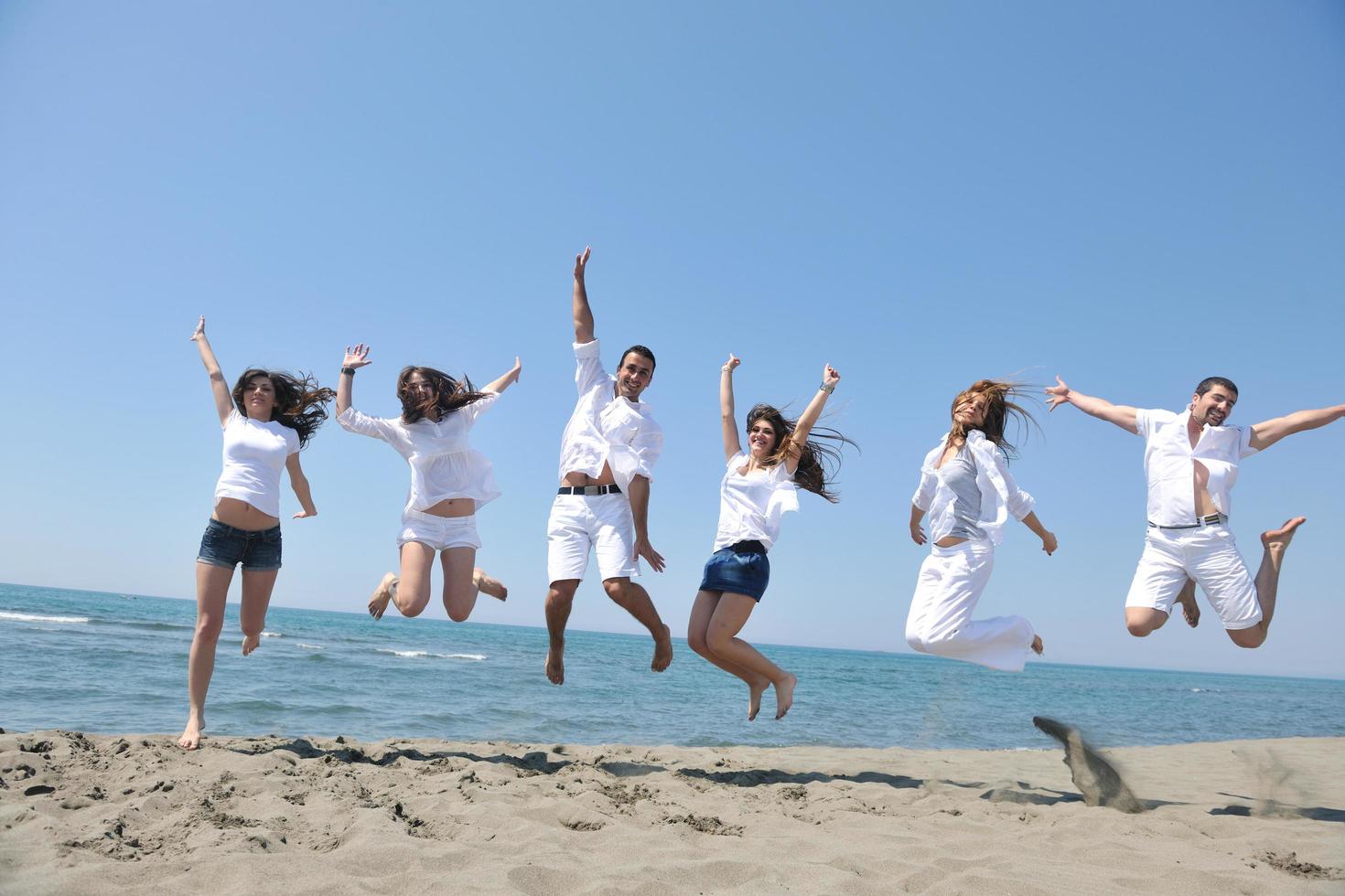 happy people group have fun and running on beach photo