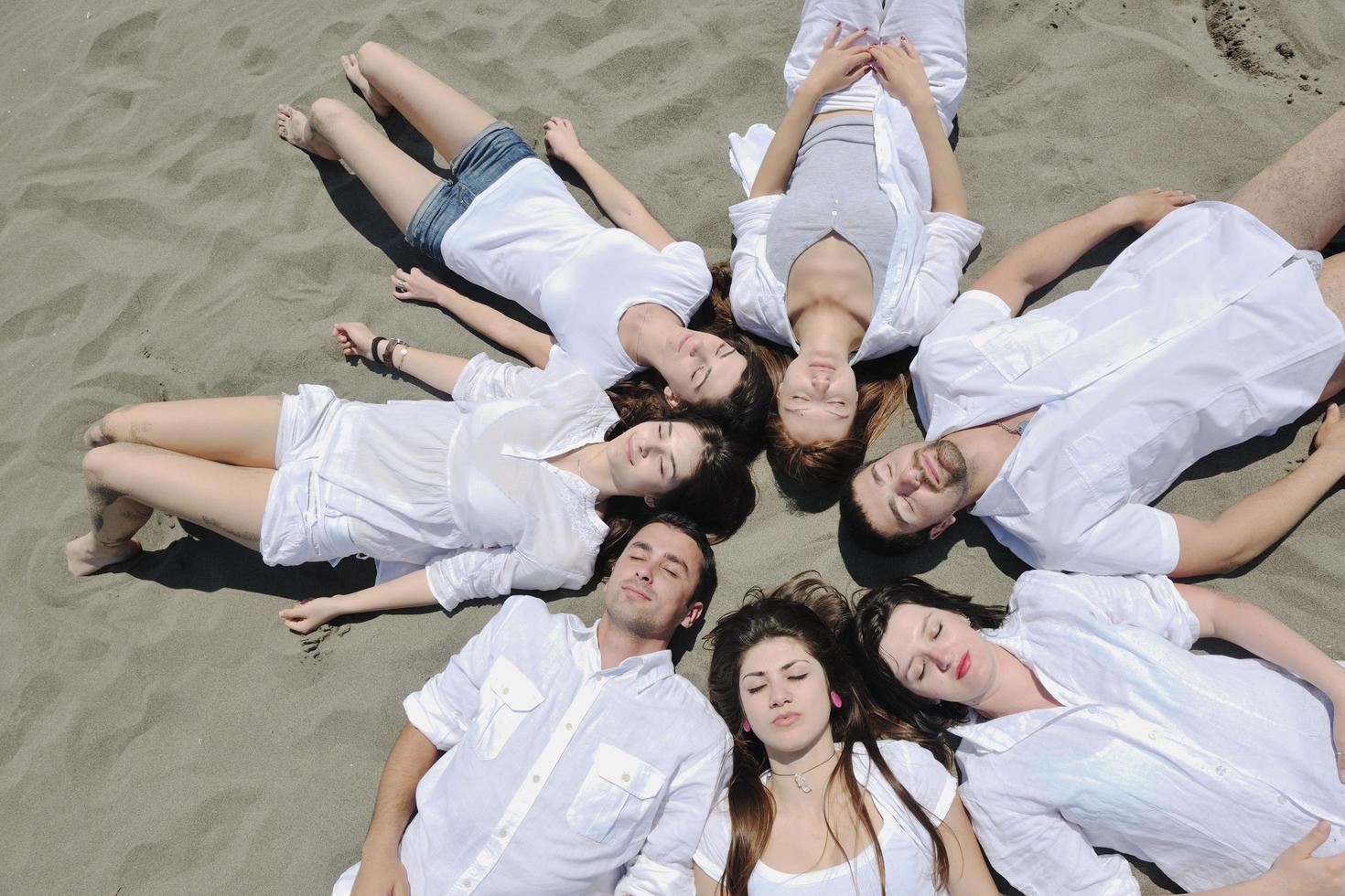 Group of happy young people in have fun at beach photo