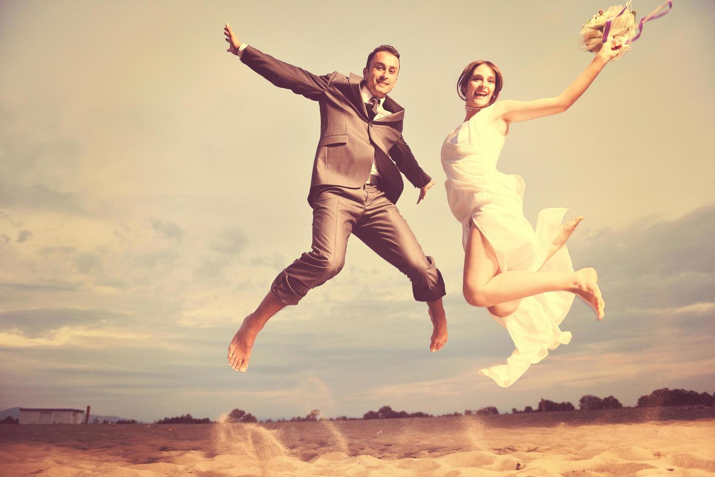 romantic beach wedding at sunset photo