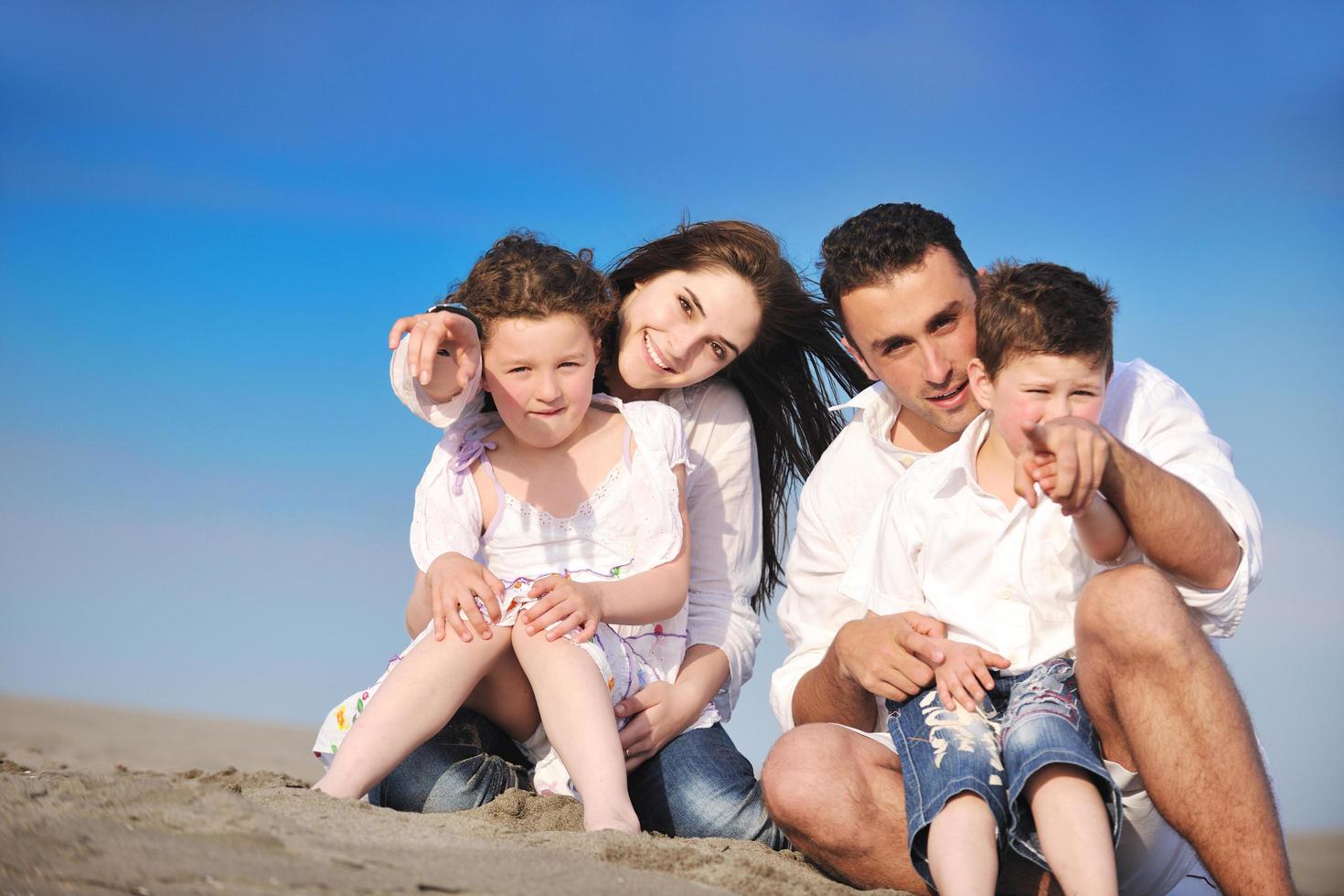 happy young family have fun on beach photo