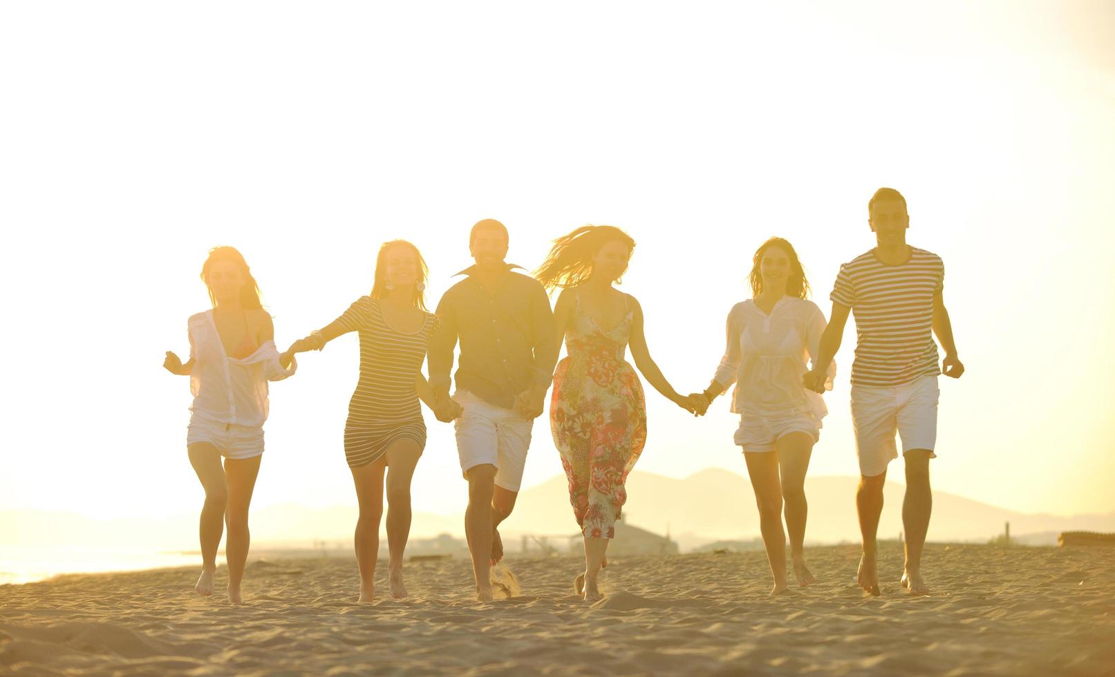 happy young  people group have fun on beach photo