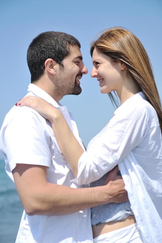 happy young couple have fun on beach photo