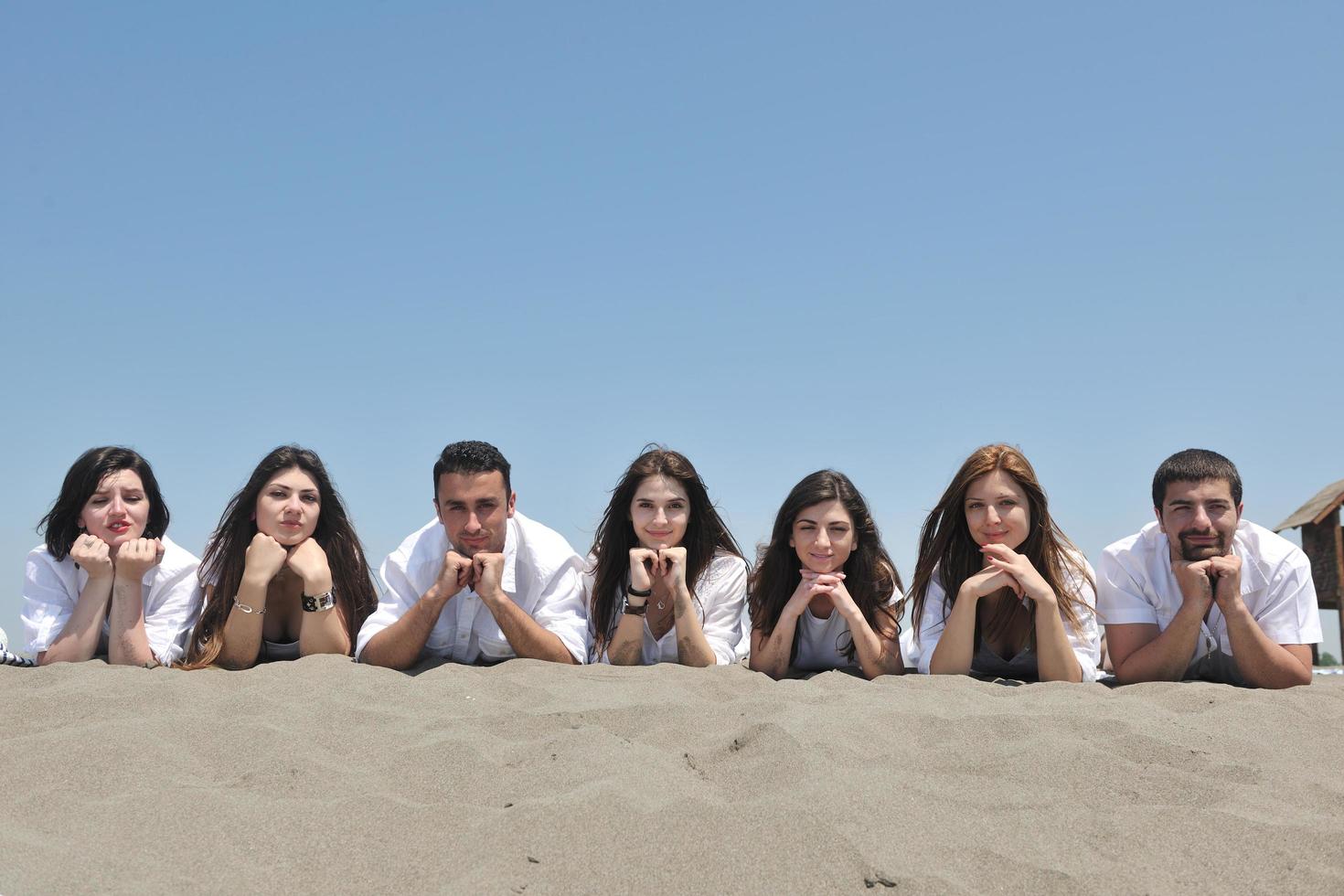 Group of happy young people in have fun at beach photo