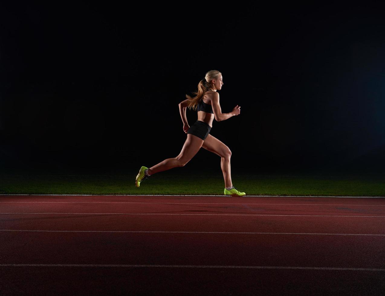 Athletic woman running on track photo