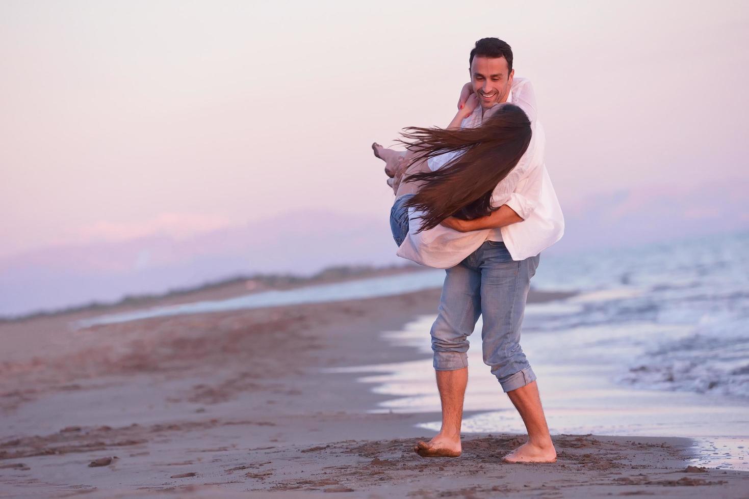 young couple  on beach have fun photo