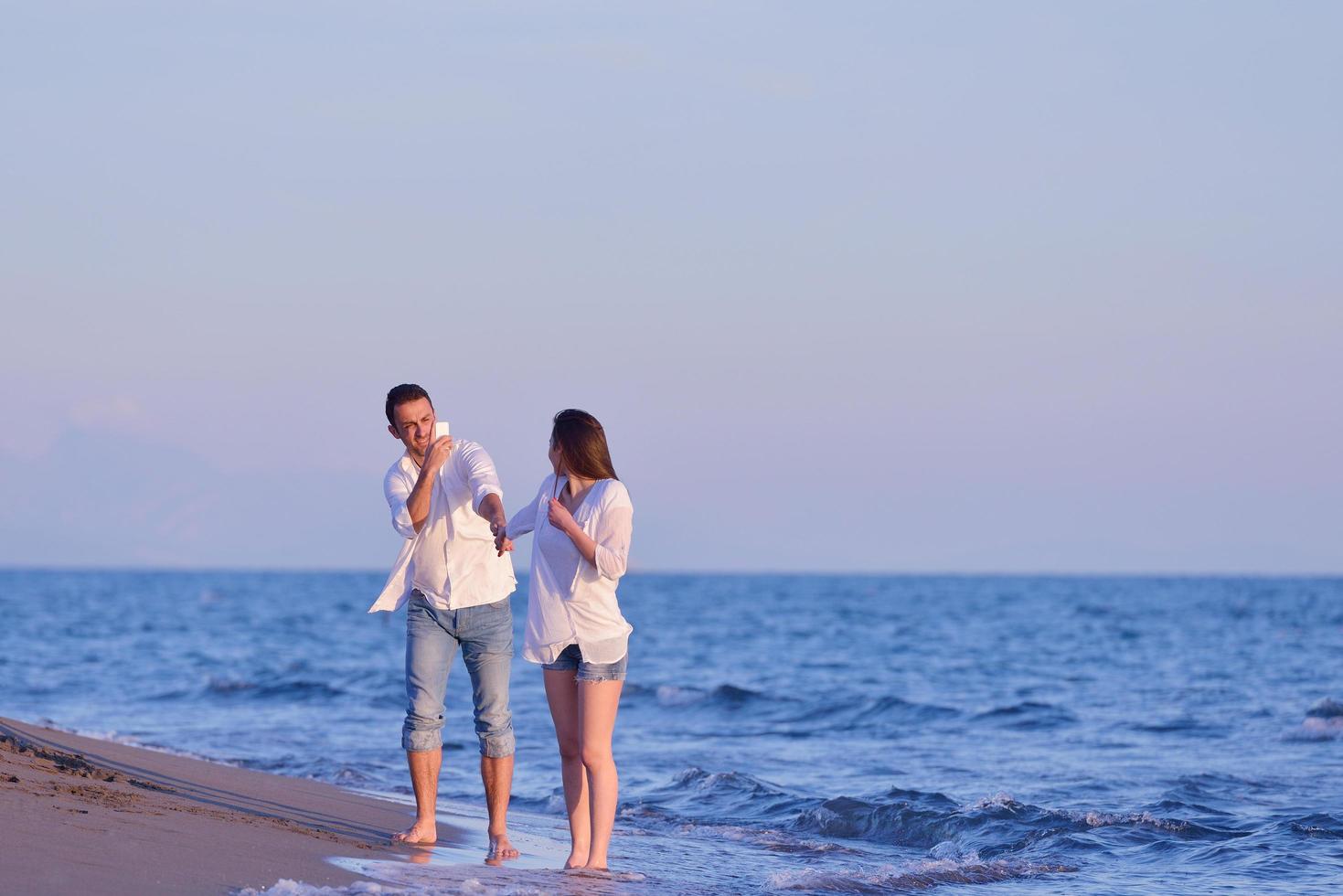 young couple  on beach have fun photo