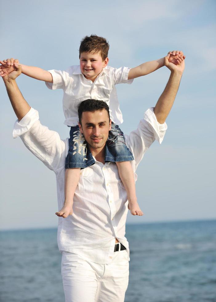happy father and son have fun and enjoy time on beach photo