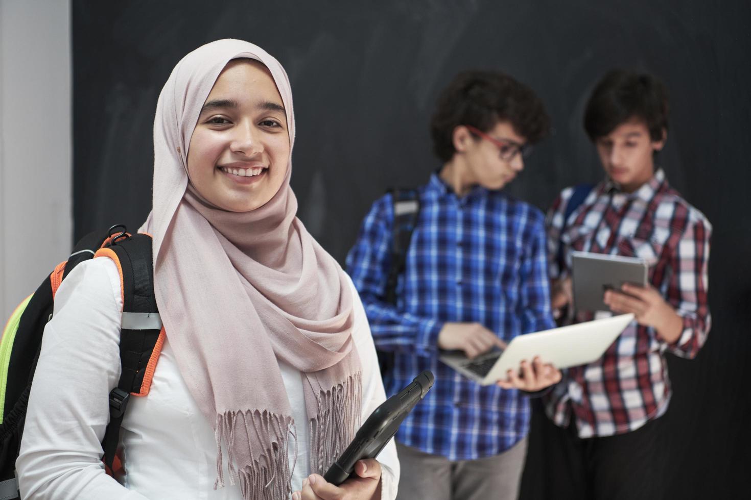 Arab teenagers group working on laptop and tablet computer photo