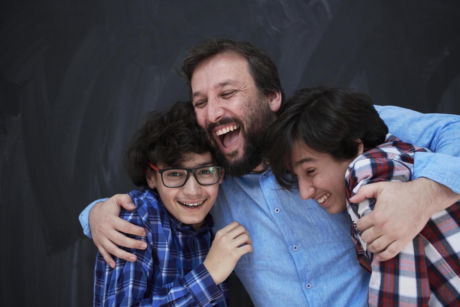 happy father hugging sons photo