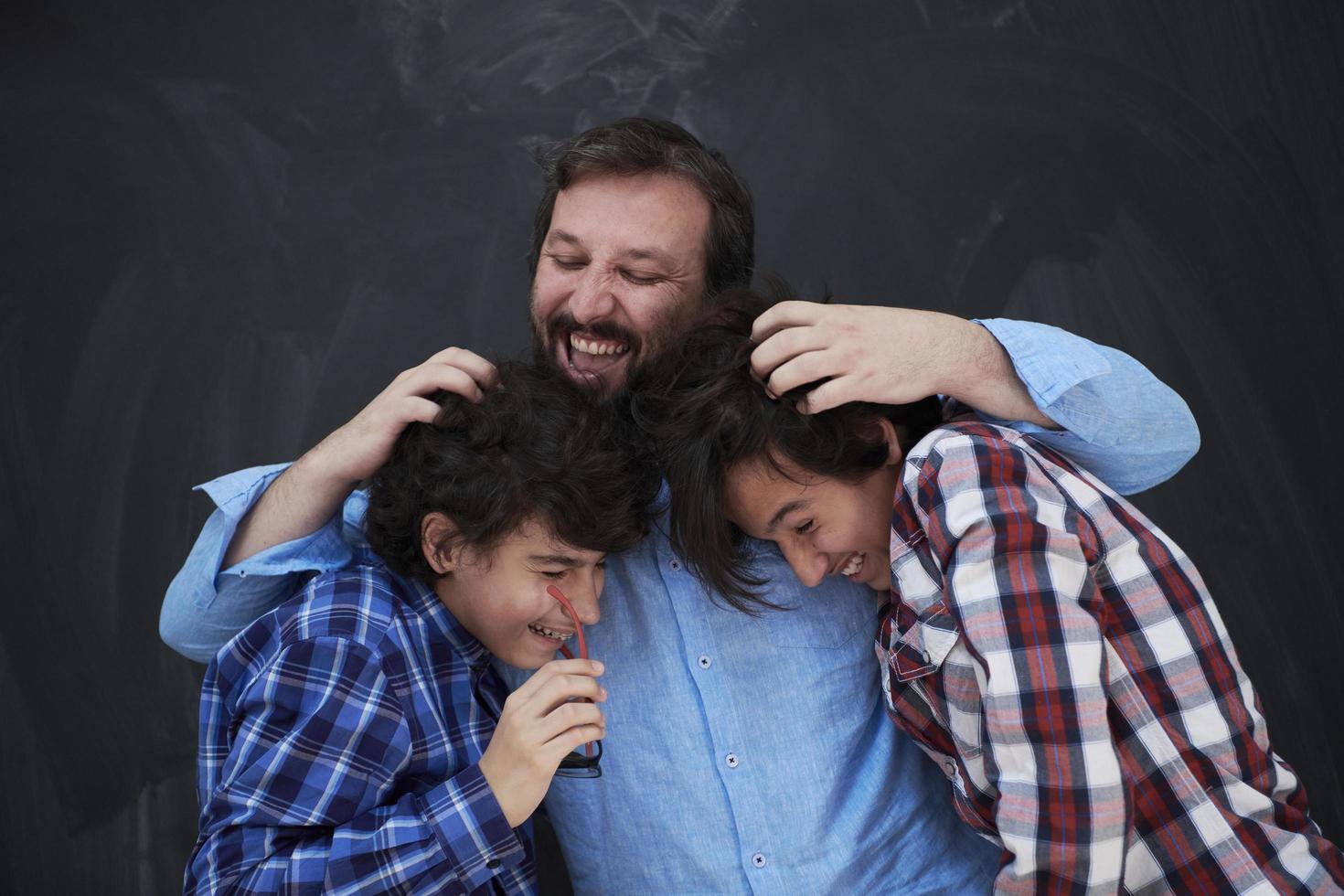 happy father hugging sons photo