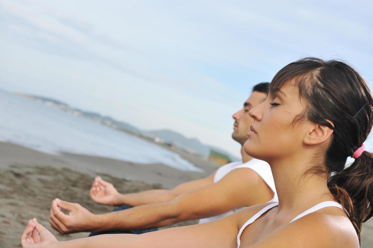 couple yoga beach photo