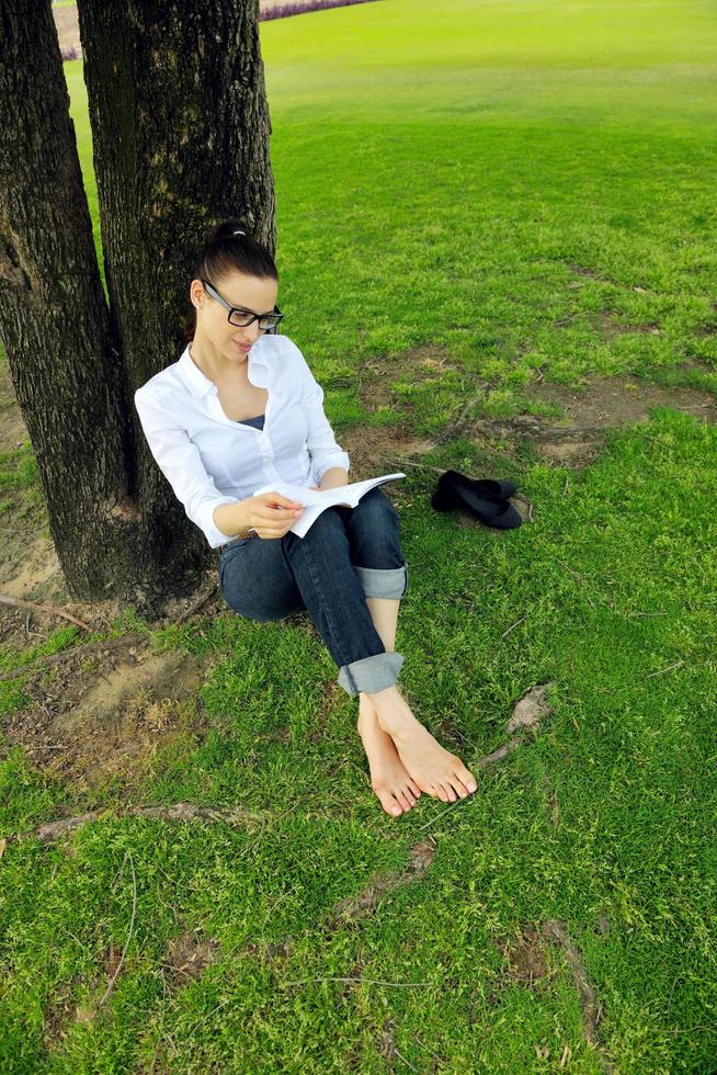 Young woman reading a book in the park photo