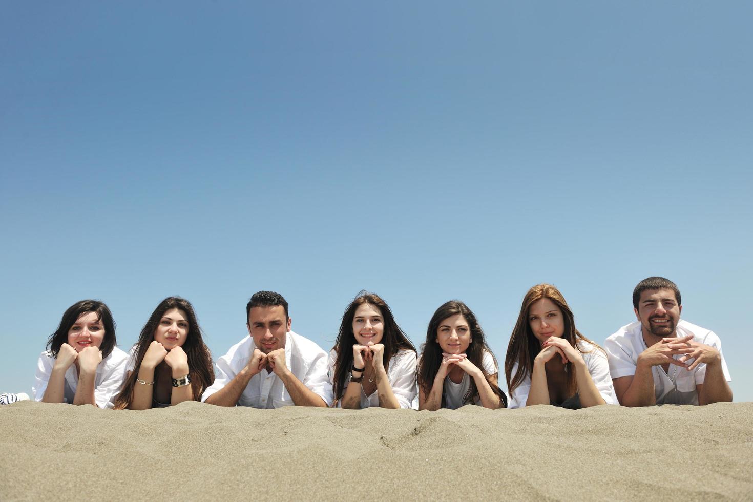 Group of happy young people in have fun at beach photo