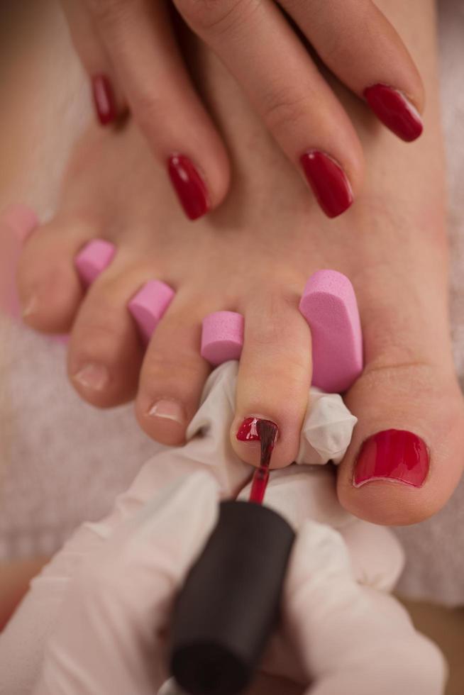 female feet and hands at spa salon photo