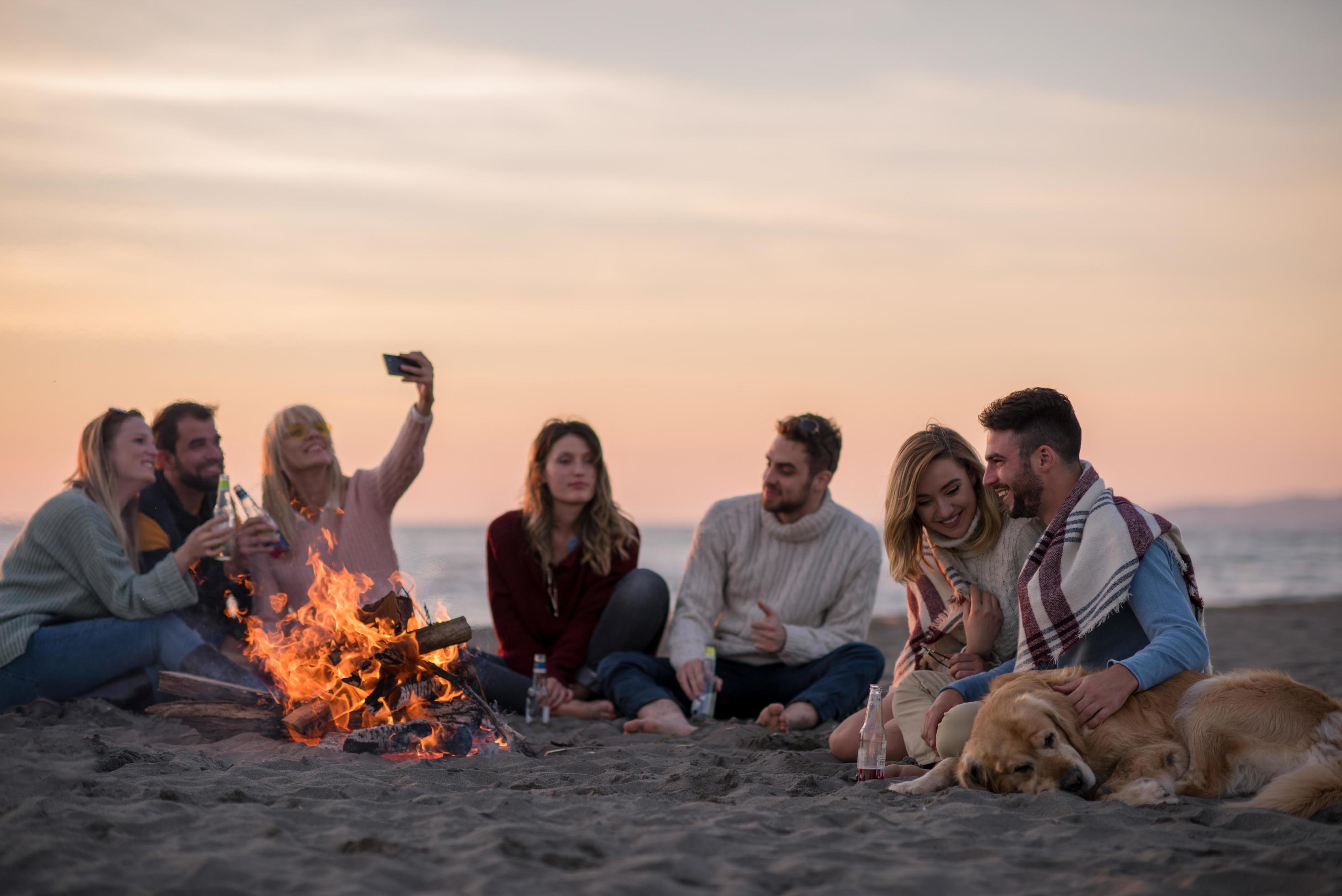 Friends having fun at beach on autumn day 12654024 Stock Photo at Vecteezy