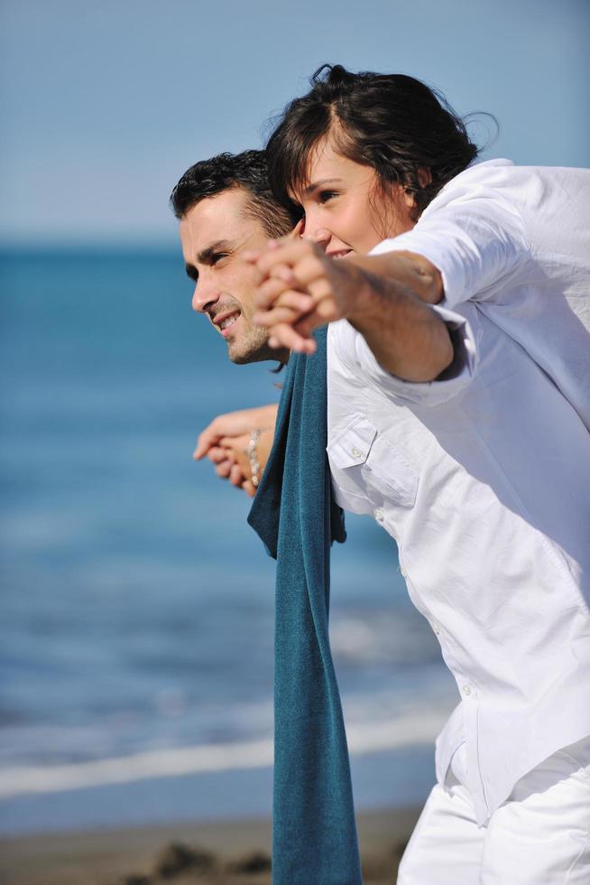 happy young couple have fun at beautiful beach photo