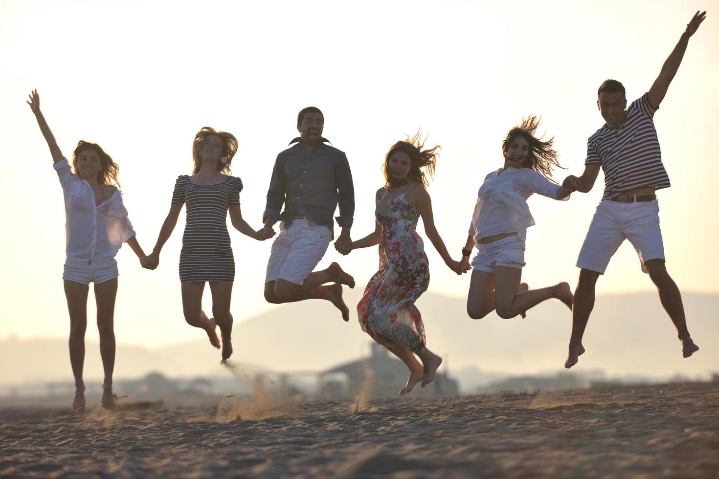 happy young  people group have fun on beach photo