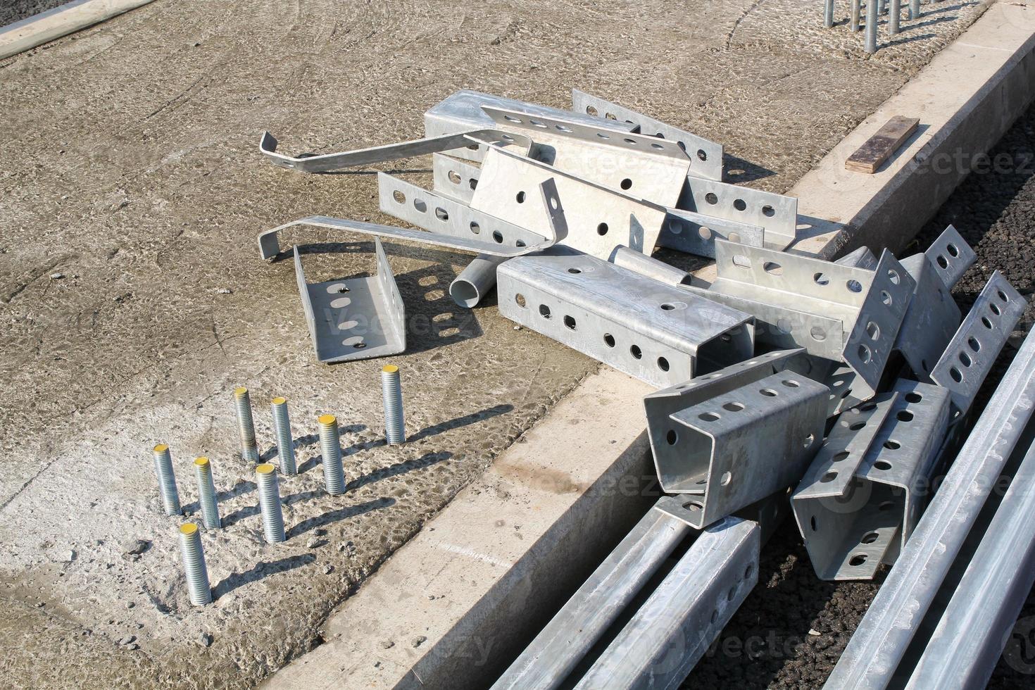 Installing a new road railing infrastructure. Steel crosspieces laying highway equipment. Construction of tracks for cars. Development and improvement of transport junction. Erection overpass in city photo