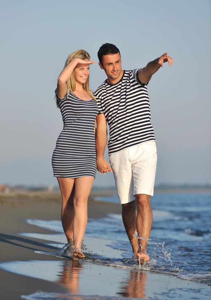happy young couple have romantic time on beach photo