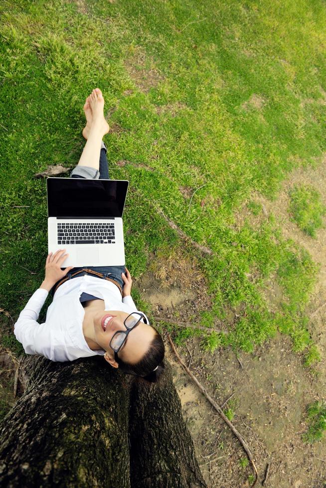 woman with laptop in park photo