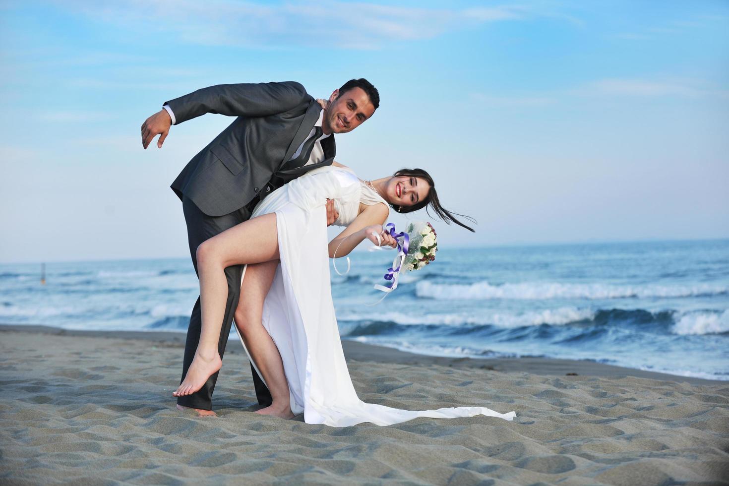 romantic beach wedding at sunset photo