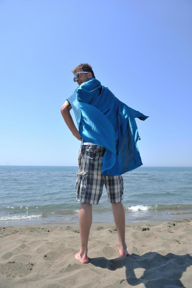 funny superhero standing on beach photo