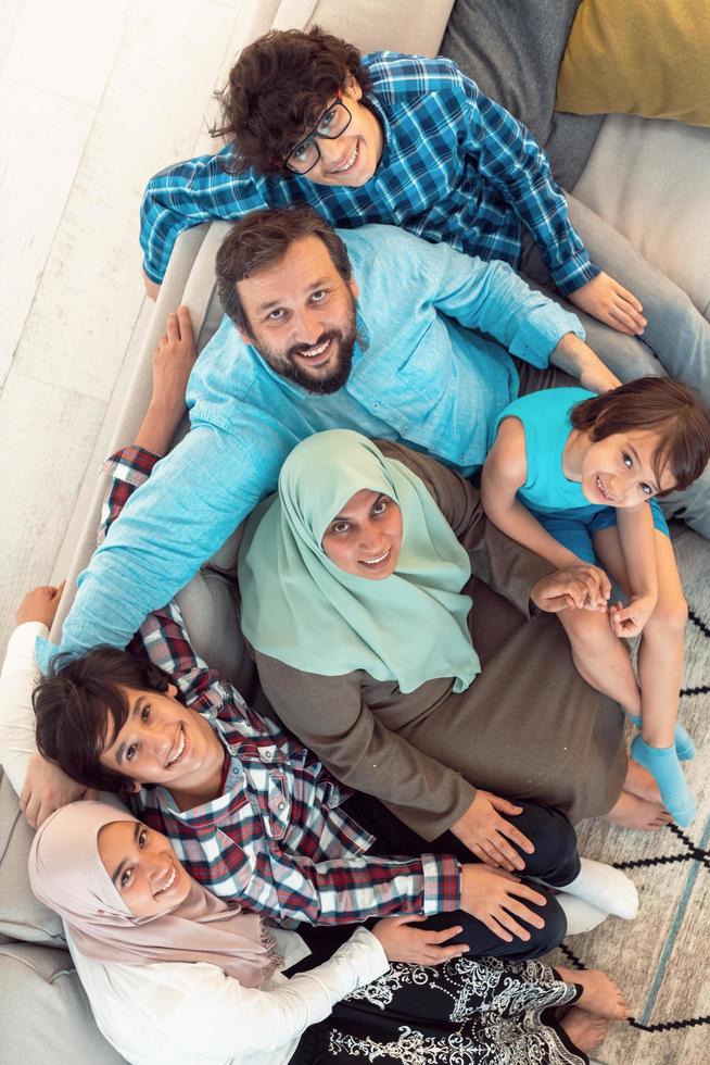 Top view photo of an Arab family sitting in the living room of a large modern house.Selective focus