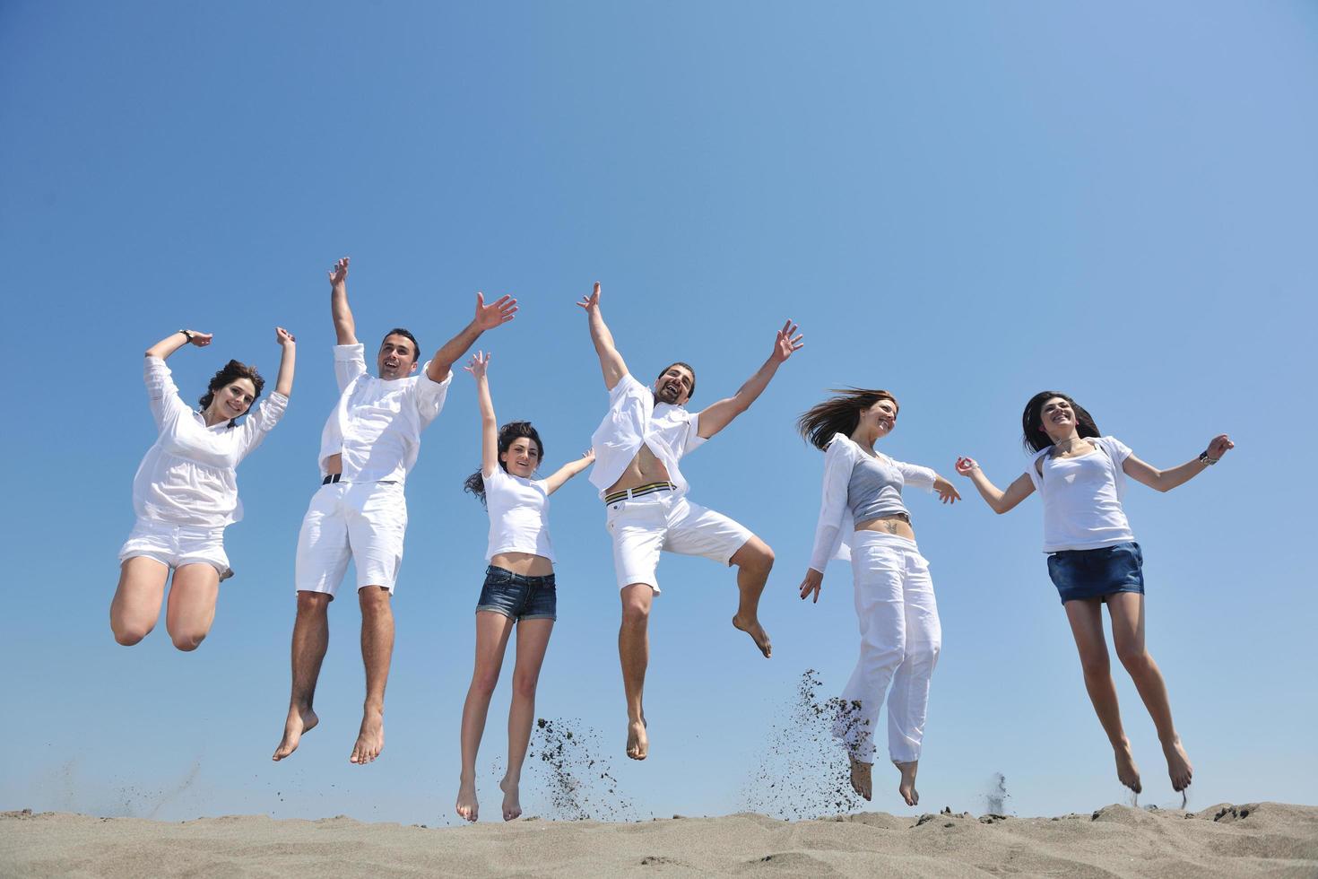 happy people group have fun and running on beach photo