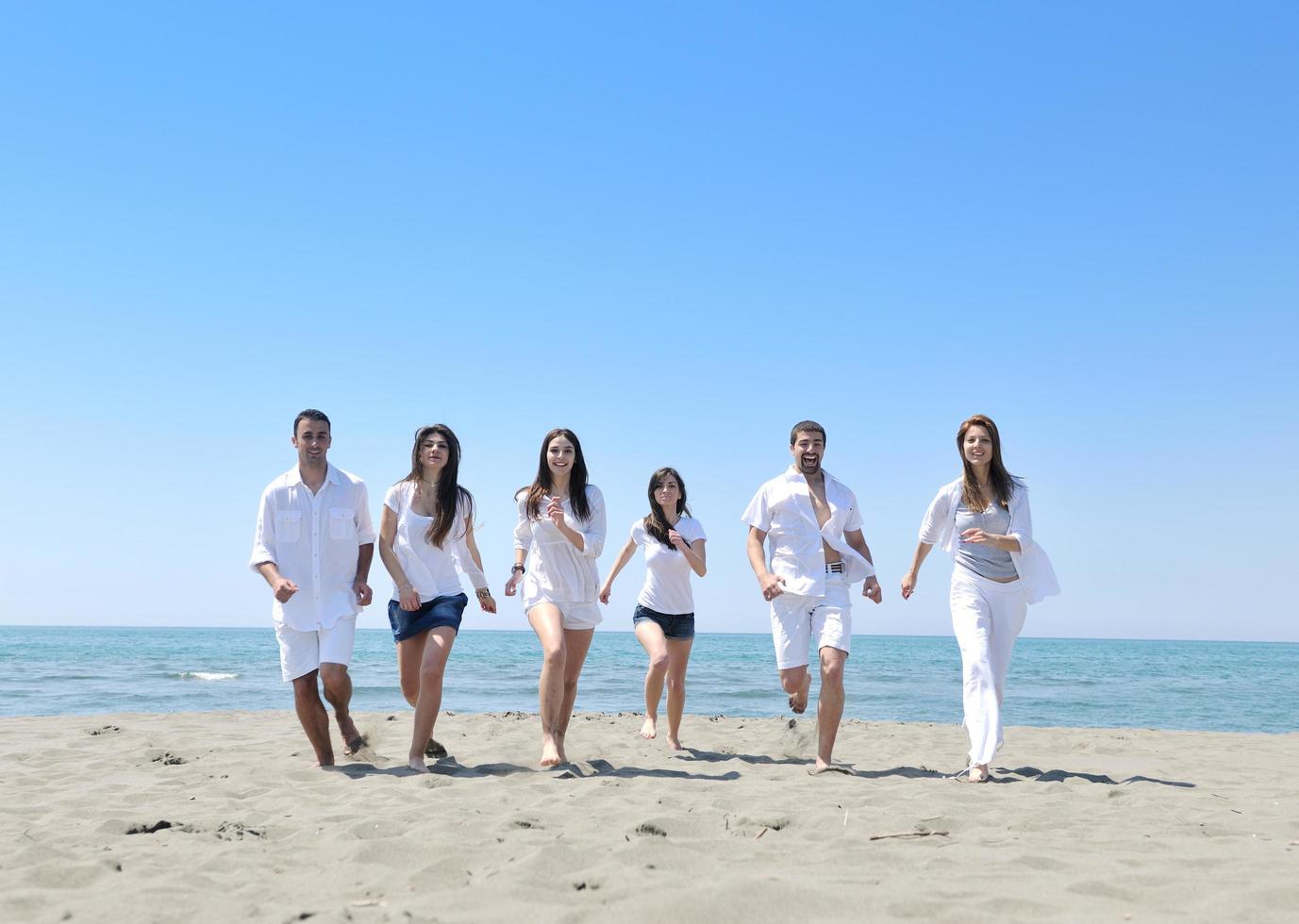 happy young  people group have fun on beach photo