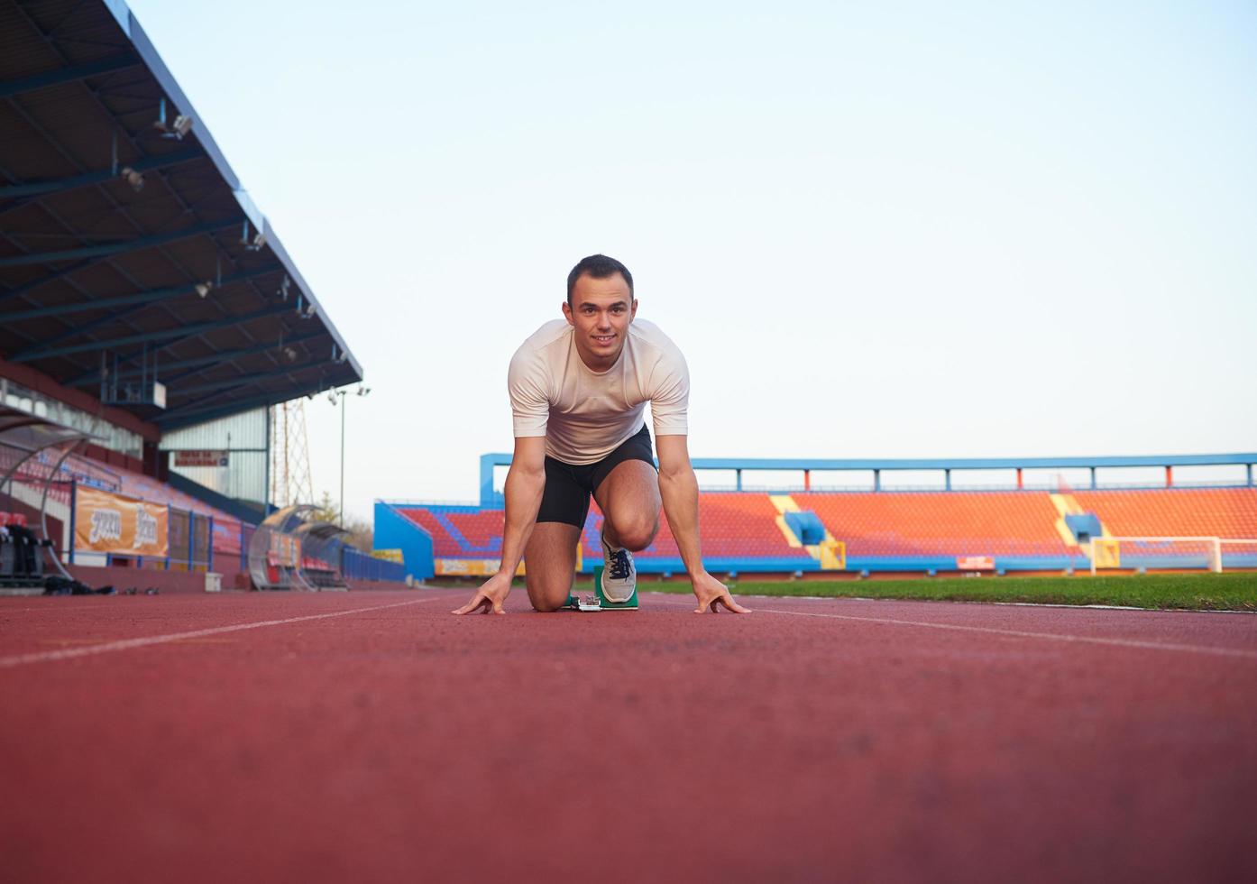 pixelated design of woman  sprinter leaving starting blocks photo