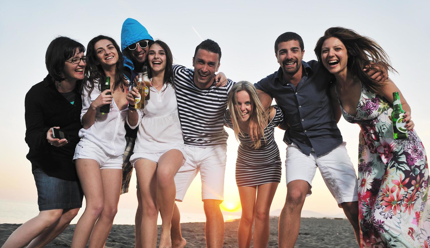 Group of young people enjoy summer  party at the beach photo