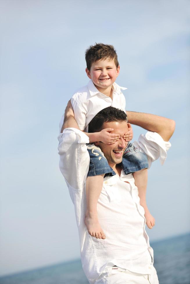 happy father and son have fun and enjoy time on beach photo