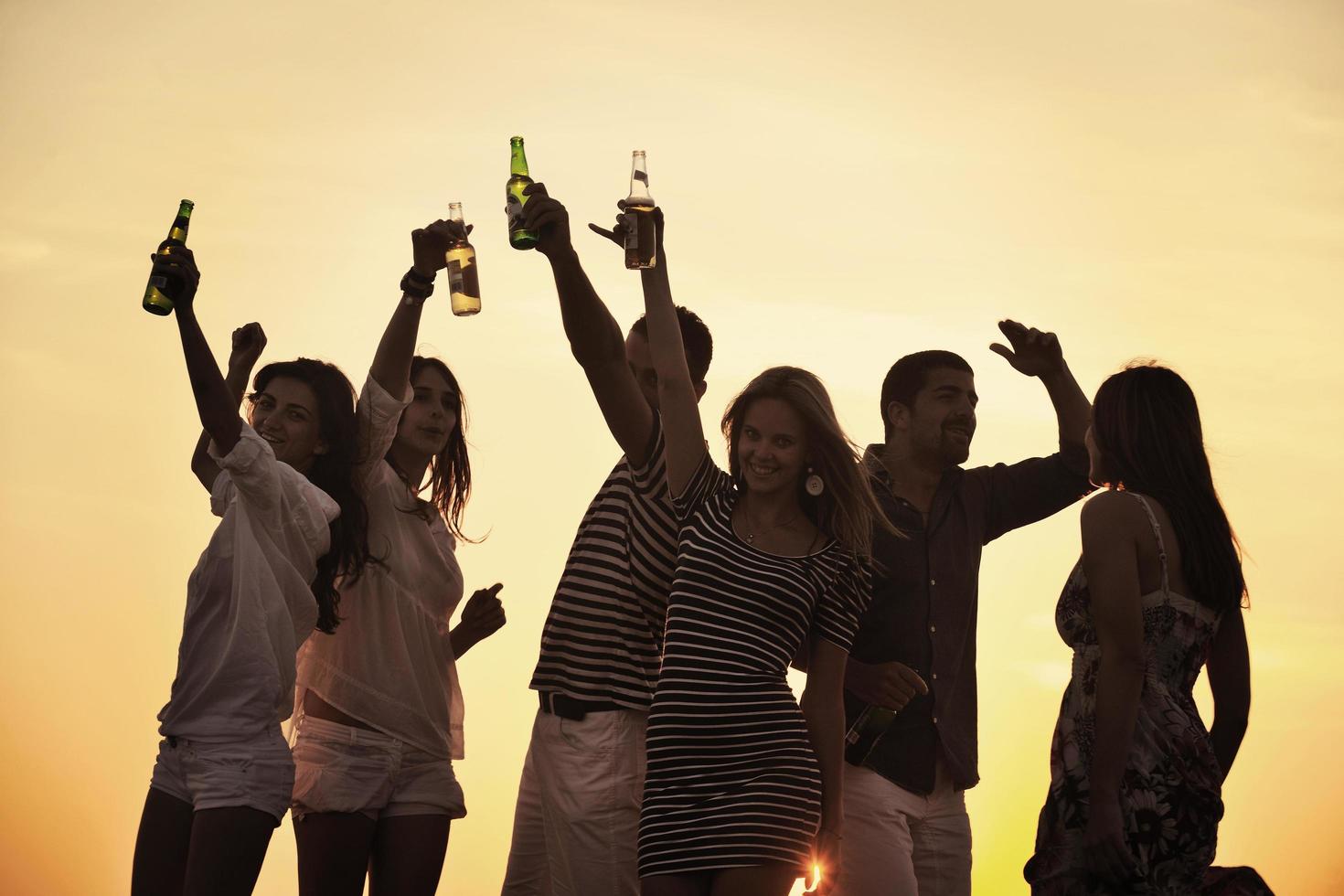 Group of young people enjoy summer  party at the beach photo