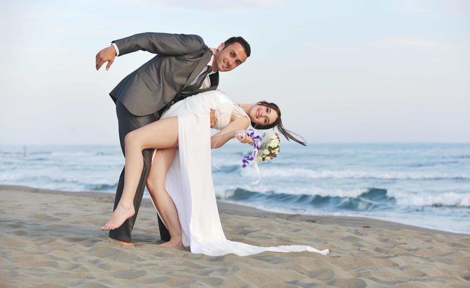 romantic beach wedding at sunset photo