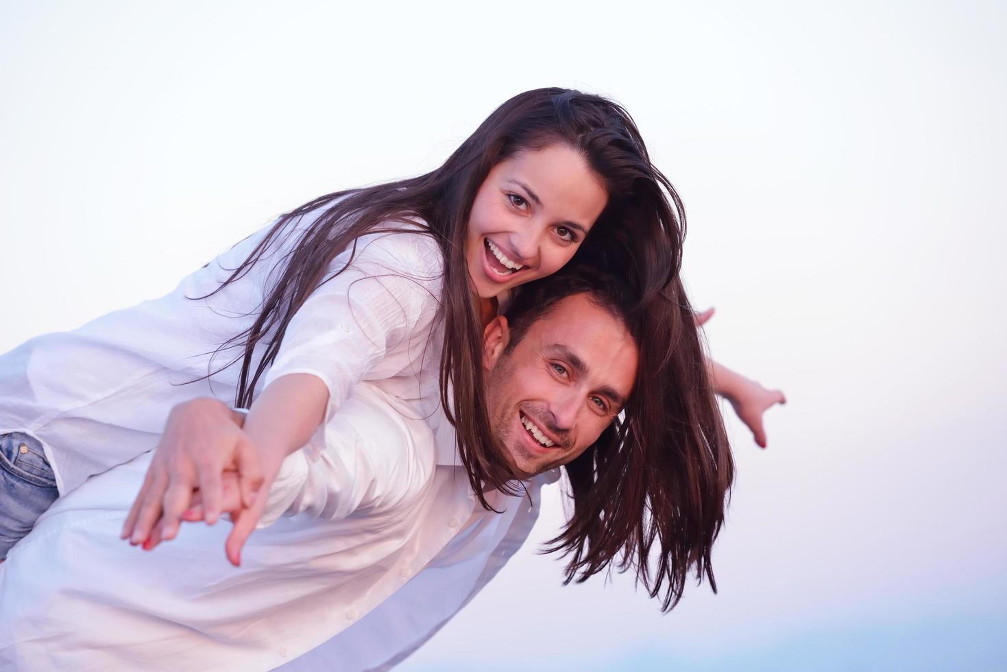 young couple  on beach have fun photo