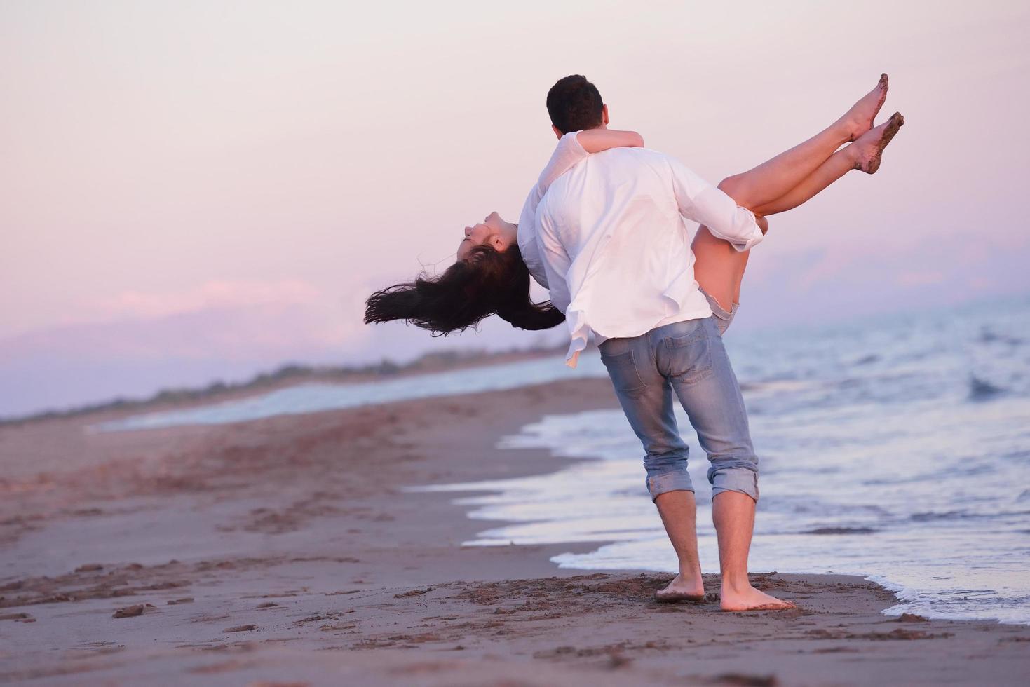 young couple  on beach have fun photo