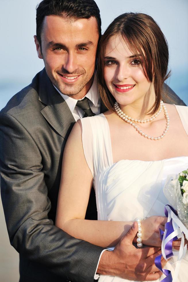 romantic beach wedding at sunset photo