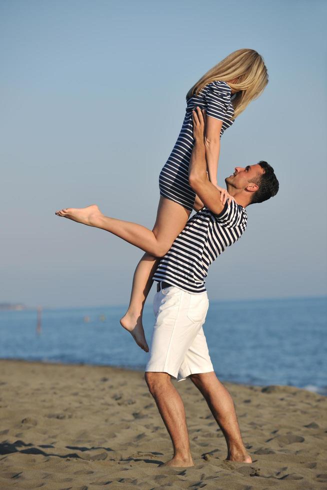 happy young couple have romantic time on beach photo