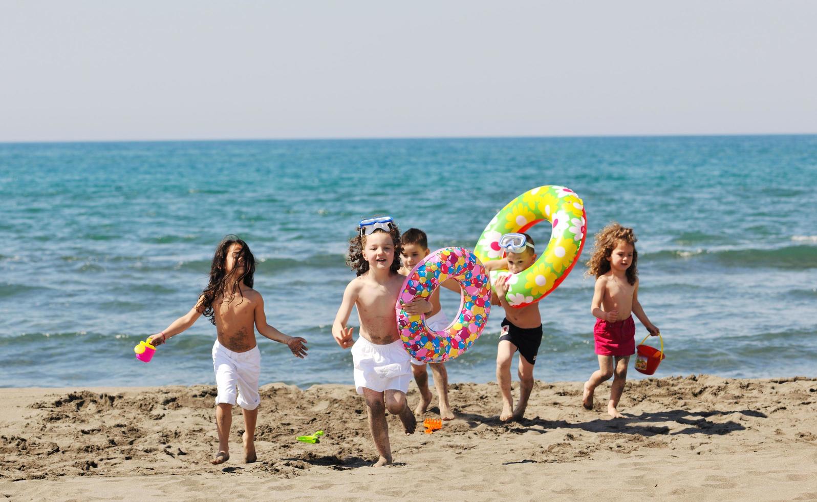 child group have fun and play with beach toys photo