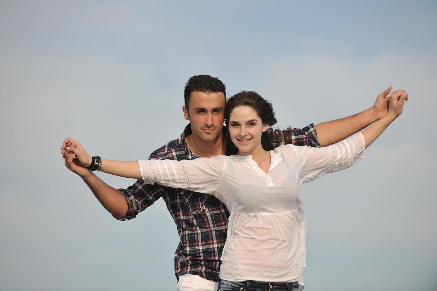 happy young couple have fun on beach photo