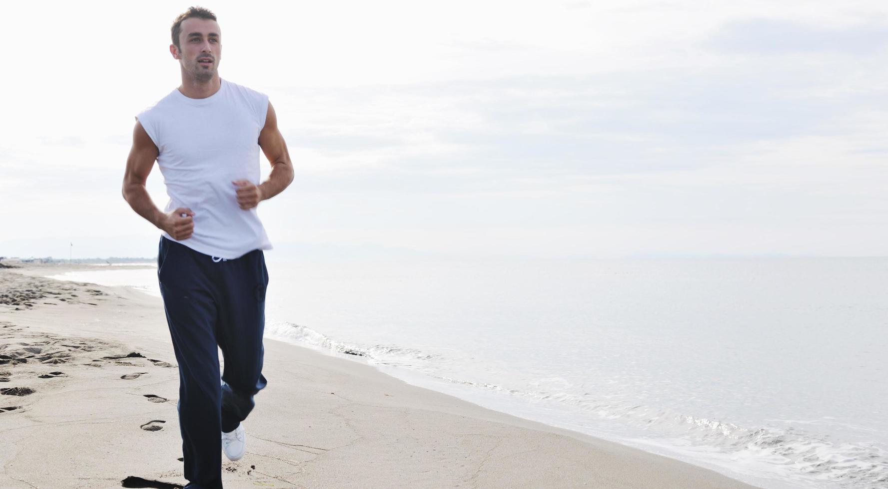man running on beach photo
