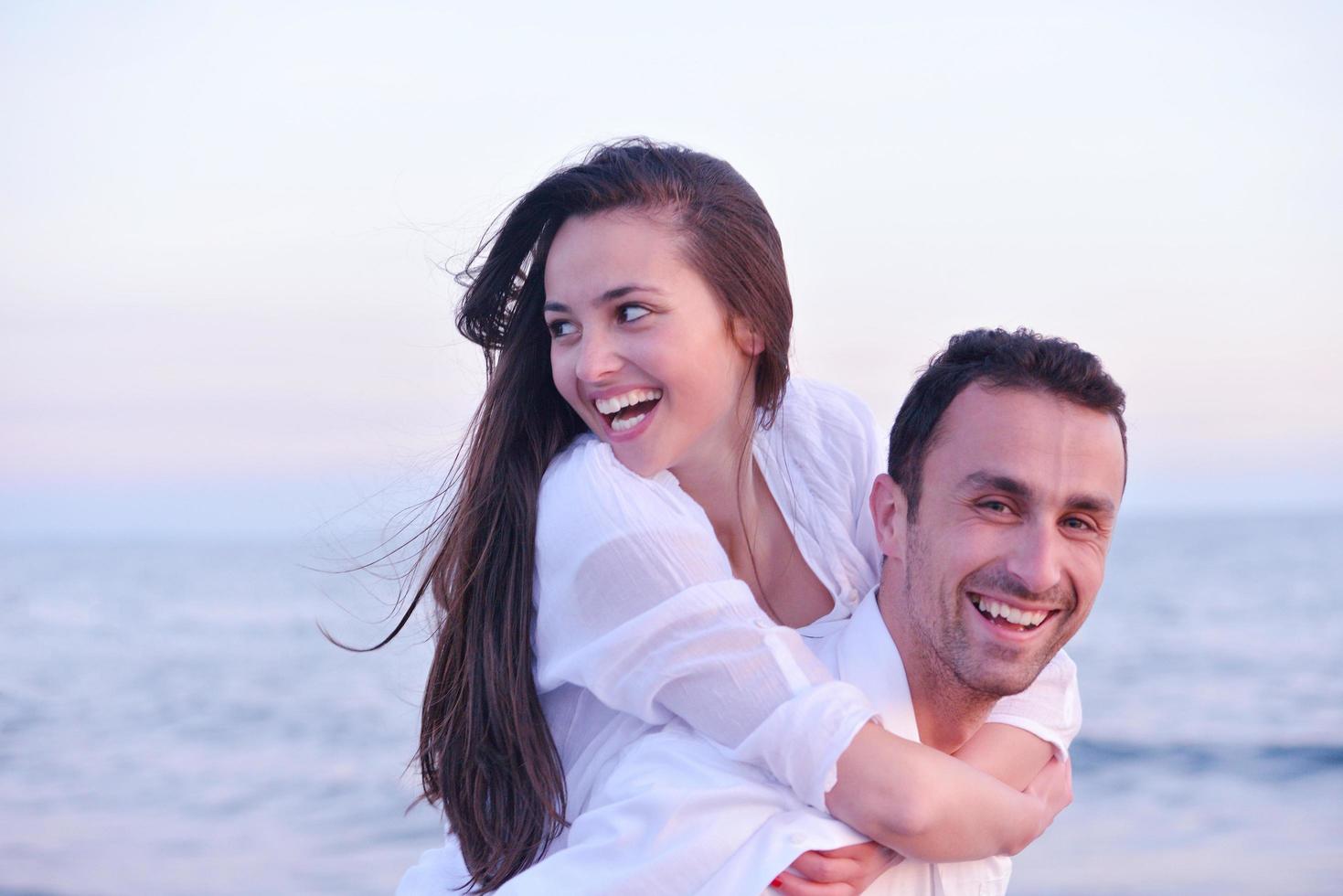 young couple  on beach have fun photo