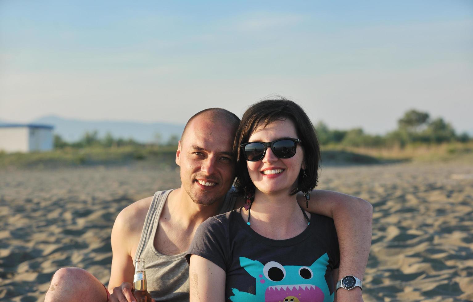 happy young couple have fun on beach photo