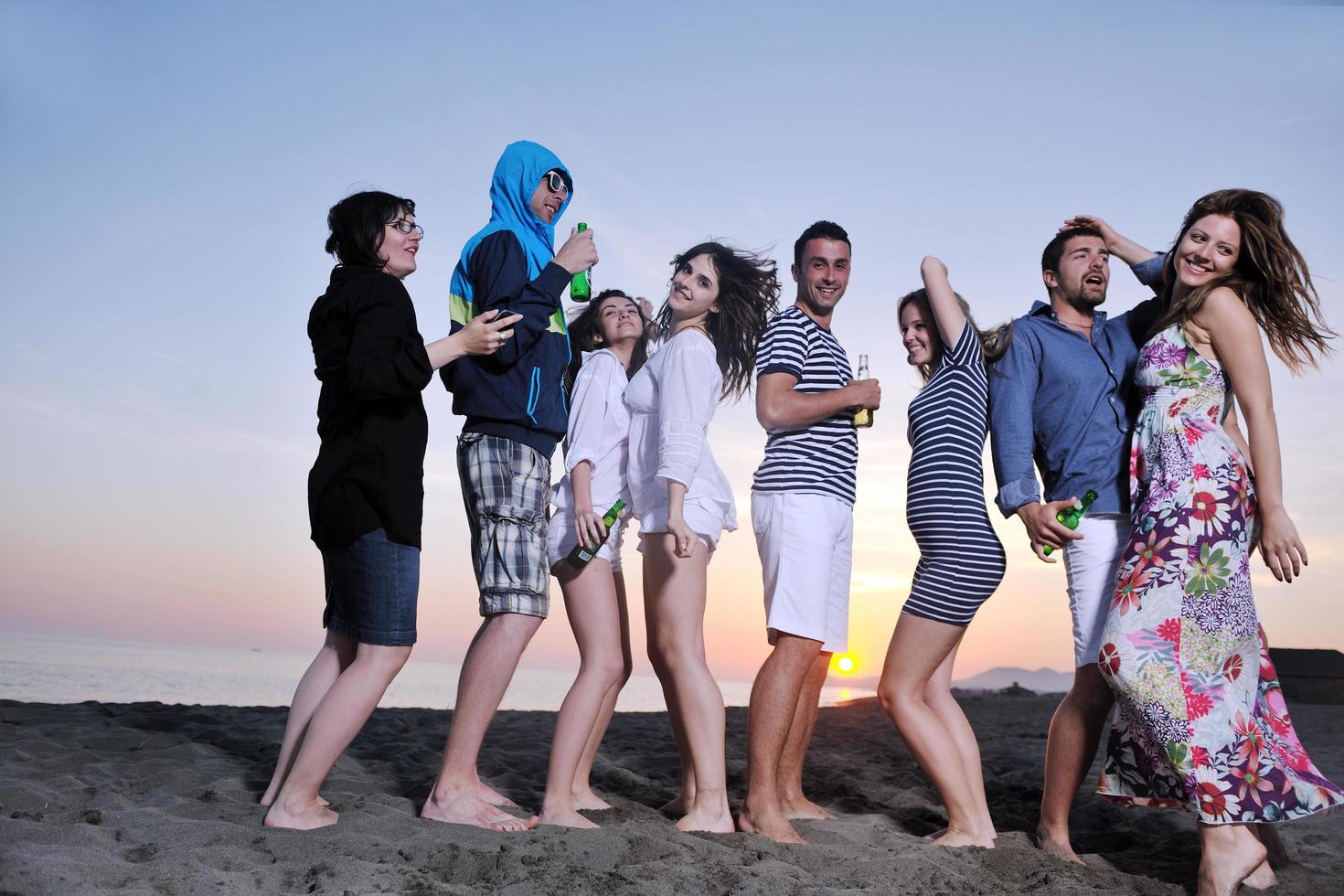 Group of young people enjoy summer  party at the beach photo