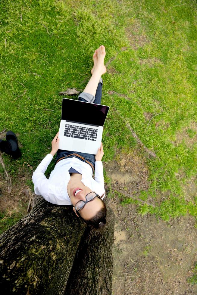 woman with laptop in park photo