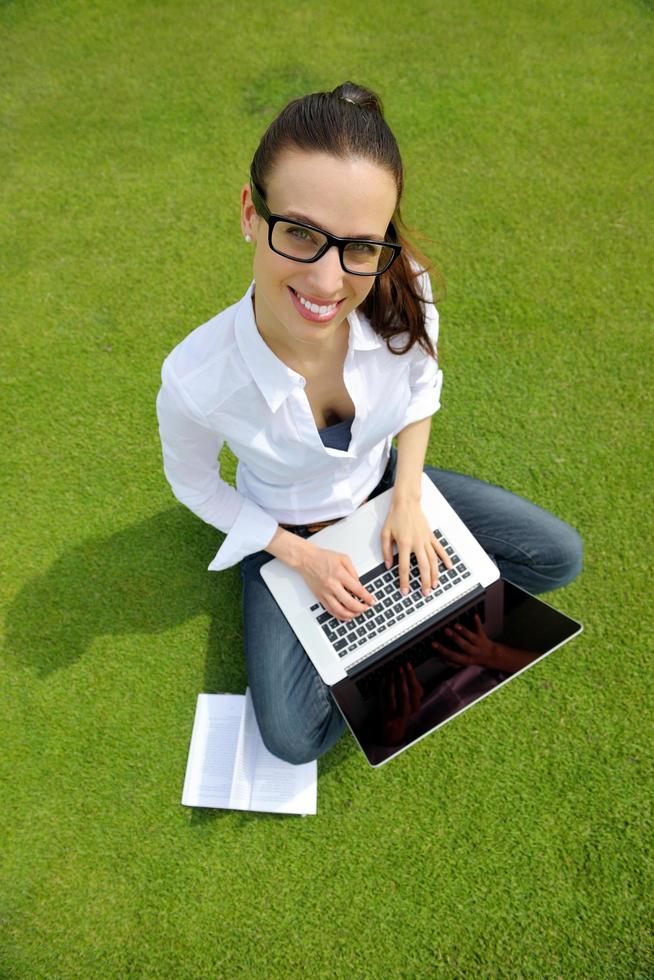 woman with laptop in park photo